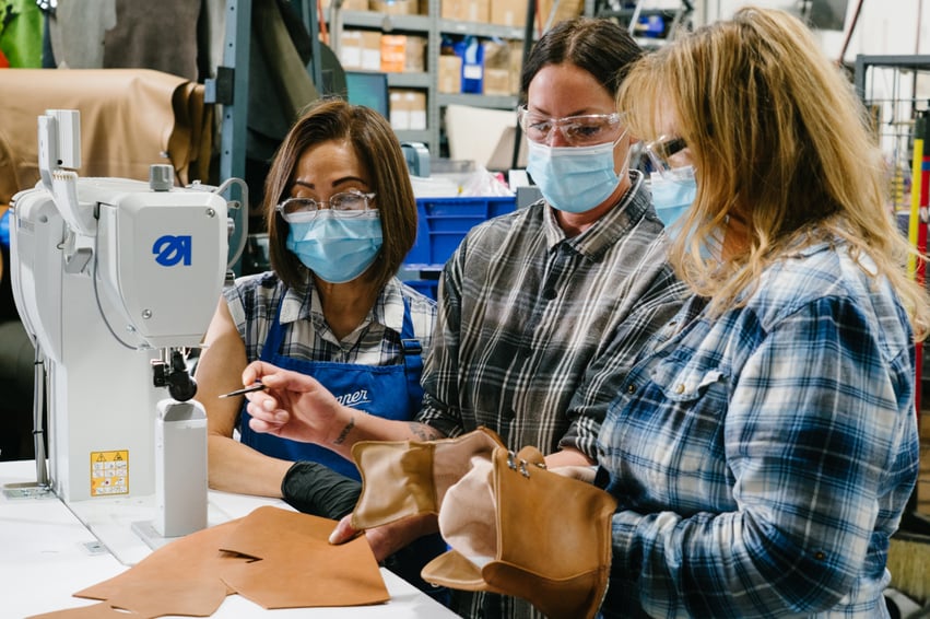 A man is using a computer to design a pair of Danner Boots.